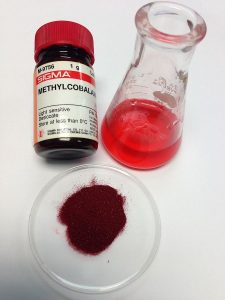 Methylcobalamin forms a dark red crystal. By Sbharris (Steven B. Harris) (Own work) [CC BY-SA 3.0], via Wikimedia Commons