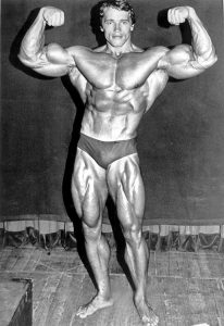 Arnold Schwarzenegger, 1974. By Madison Square Garden Center (RMY Auctions) [Public domain], via Wikimedia Commons