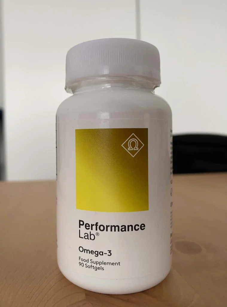 A bottle of Performance Lab Omega-3 sitting on a table in a room
