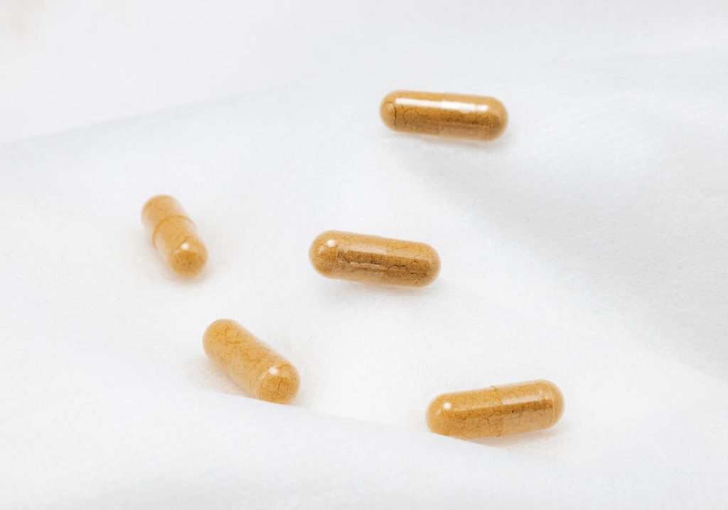 Herbal capsules with a white background representing joint supplements