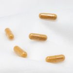 Herbal capsules with a white background representing joint supplements